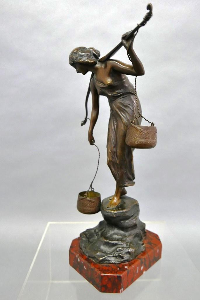 P. Kowalczewski Female Water Carrier Bronze Statue: Paul Ludwig Kowalczewski [Poland & Germany / 1865 to 1910] bronze statue of a female water carrier mounted on a colorful marble base 13.25" high overall, signed on base