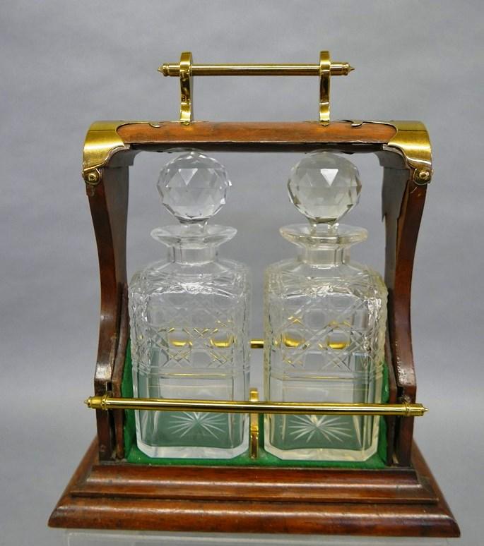Antique Tantalus With Decanters: Antique wood Tantalus with brass handle, lock and trim, original green felt lining, contains two matching decanters with stoppers, 11"W, 5.5"D, 13"H