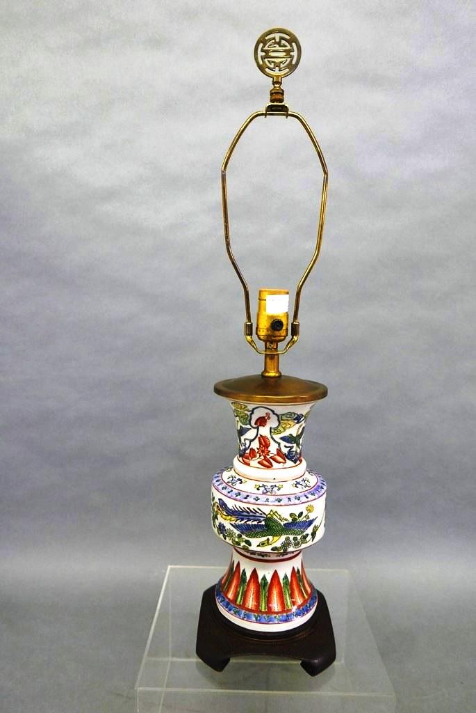 Vintage Maitland-Smith Table Lamp: Vintage hand painted china lamp decorated with phoenixes, clouds, flowers and feathers, copper colored metal mounting on a hardwood base, original Maitland-Smith label dated 1985, 26"H to top of finia