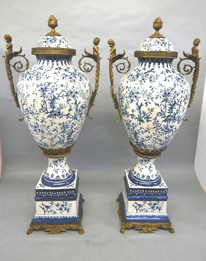 Pair Of Large Chinese Palace Urns: Pair of large Chinese hand painted covered urns or floor vases, hand painted blue birds and flowers decoration with bronze colored metal mounts, cherub handles, 39"H, 17"W between handles