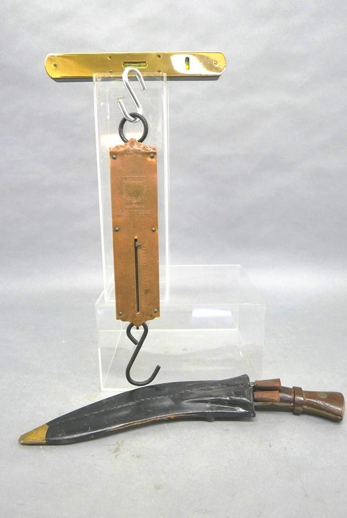 Dagger, Scale & Level: Large Indian kukri curved dagger with two smaller knives in a leather scabbard with brass tip 17.5"L, antique Chatillons iron and brass 40 pound hanging scale 15"H, contemporary brass and hardwood lev