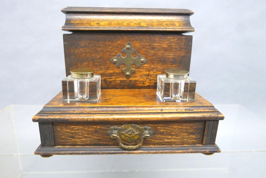 Victorian Oak Writing Desk Top Stand: Antique oak writing set, hinged lid covers letter and envelope slots and a pen rest with hidden compartment underneath, front has two exposed crystal inkwells with worn silver-plated lids, single draw