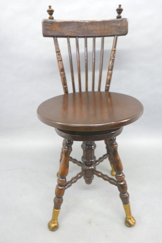 Antique Piano Stool: Antique piano stool with spindle back, spinning seat and iron feet 31"H