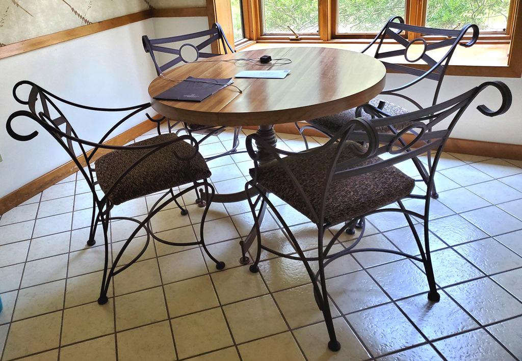 Breakfast Table & Four Iron Chairs: Formica top breakfast table 42" diameter plus a 18" extension, 29.5"H, includes a set of four matching iron armchairs 34"H with upholstered seats