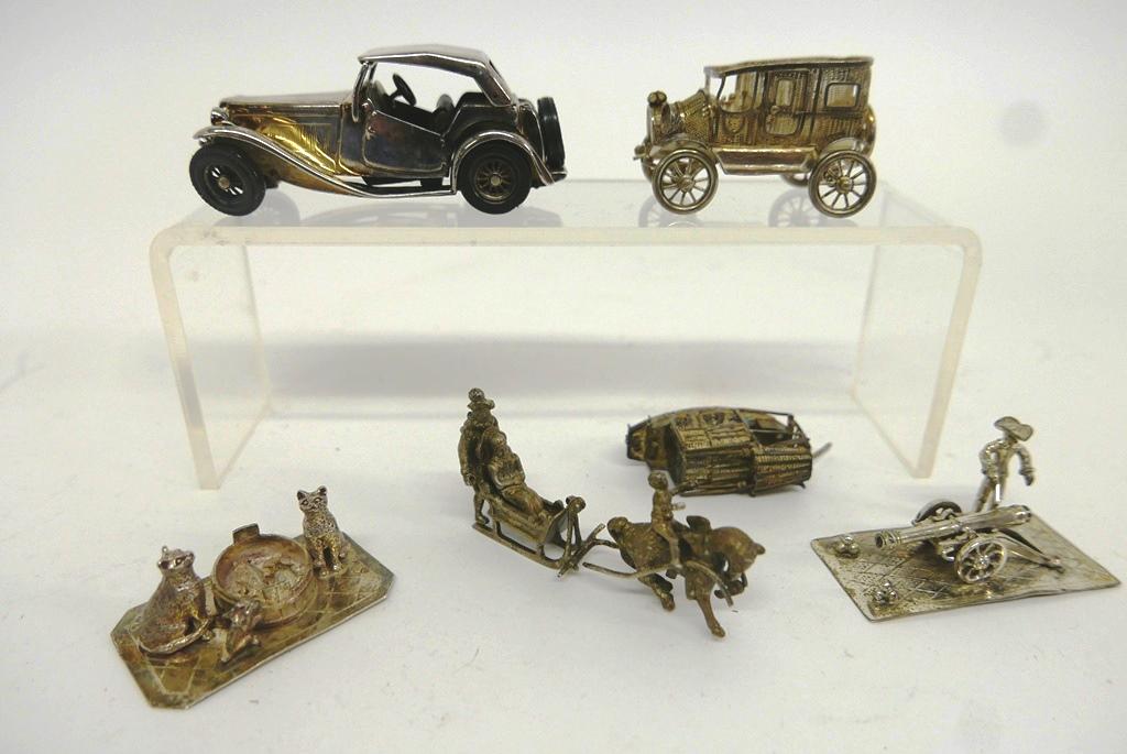 Sterling & Silver-Plate Miniatures: Nice grouping of small collectibles, MG roadster marked .925 with plastic tires 3.25"L, silver colored open roof sedan may be unmarked silver, Dutch sterling cannon and artilleryman, Asian silver fili