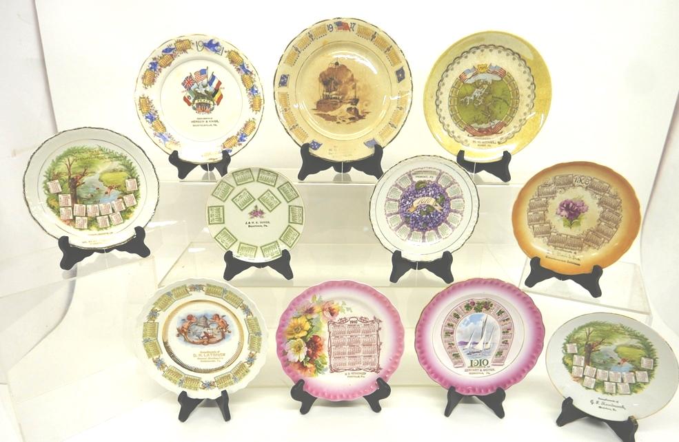 11 Antique Pennsylvania Advertising Calendar Plates: Tremont 1910 bouquet plate, Kumry 1915 Panama Canal plate, Shamokin 1910 boy's diving plate, Pikeville 1910 floral plate, Boyertown 1907 floral plate, Birdsboro 1910 boy's diving plate, Bechtelsville 