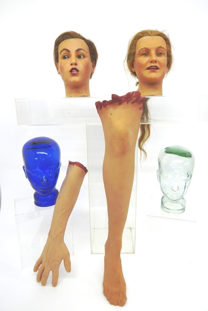 Mortician's Wax Heads & Fake Limbs: Pair of vintage life sized wax heads with glass eyes used to practice makeup on the deceased, realistic full sized rubber arm and leg, also includes two glass heads to keep wigs on