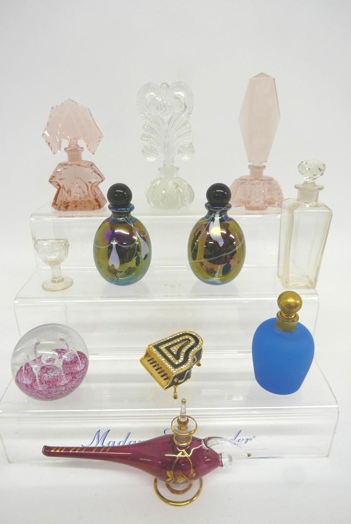 Group of Perfume Bottles & Glass Accessories: Pair of iridescent studio glass perfume bottles 5"H, hand blown blue satin glass bottle with stuck gold tilt collar and stopper 4.5"H, clear cut glass crystal bottle with tall floral cut and etched st
