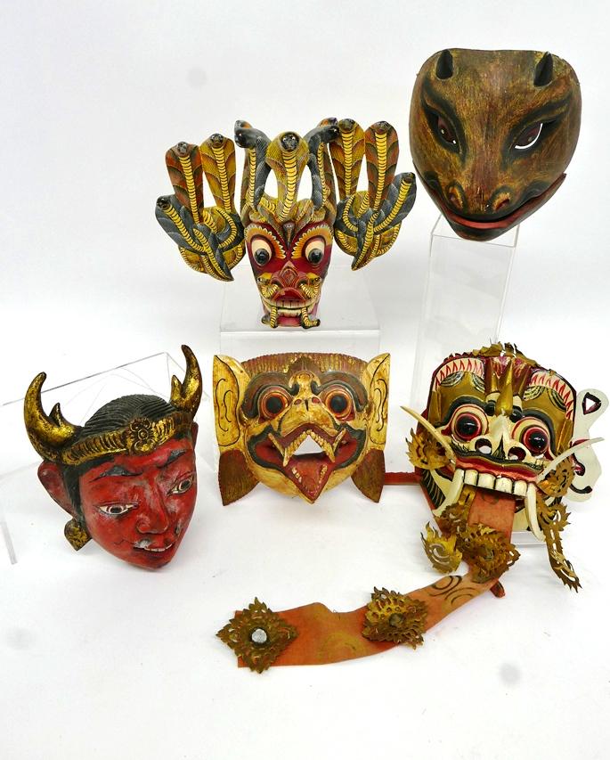 Five Carved Devil Head Masks: Five hand carved and painted wood devil masks from Indonesia and Sri Lanka, average height 10"