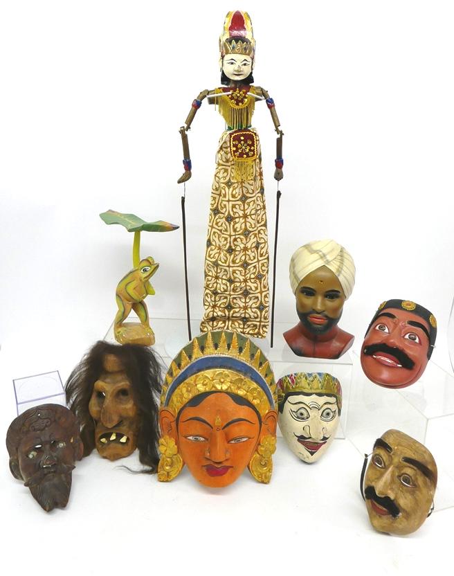 Group of Carved Wood Face Masks & Others: Swiss carved wood grotesque mask with hair 9"H, Balinese dancer marionette, Black Forrest style mask with glass eyes 8"H, Indonesian dancer plaque 13.5"H, three carved wood face masks from South Pacif