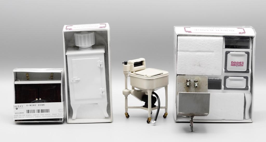 Dee's Delights Kitchen Appliances & Others: Three Dee's Delights metal appliances, monitor top refrigerator 5.25"H in original box, Roper style range 4.5"W in original box and washing machine with wringer 3.75"H, Bombay Company sink cabinet 3"W