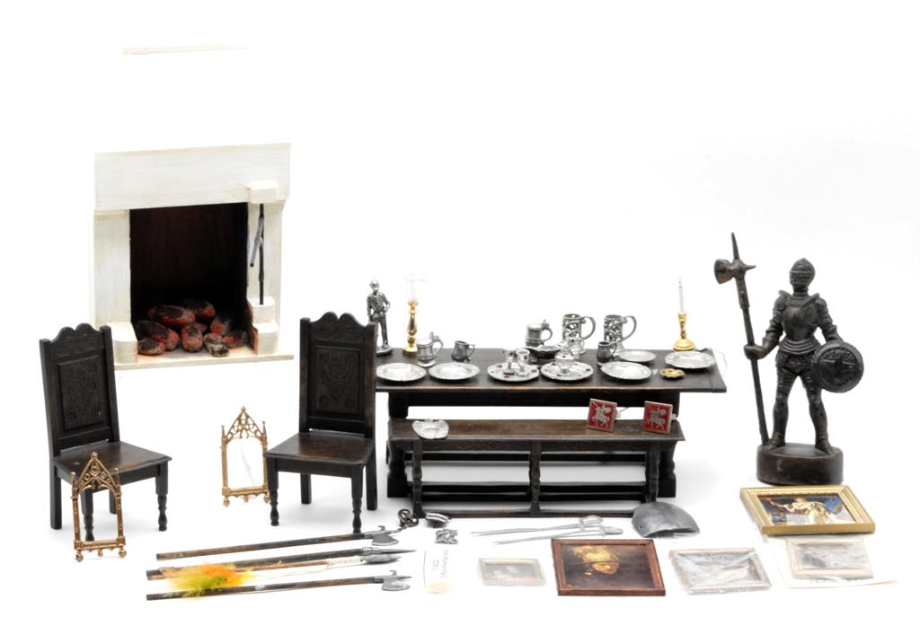 Norman Jones Tudor Dollhouse Furniture & Accessories: Signed Norman Jones refectory table with pressed design on apron and tops of legs 7.75"L with matching bench and two chairs, painted wood fireplace with metal crane and faux logs 4"W, 6.5"H, pewter ed