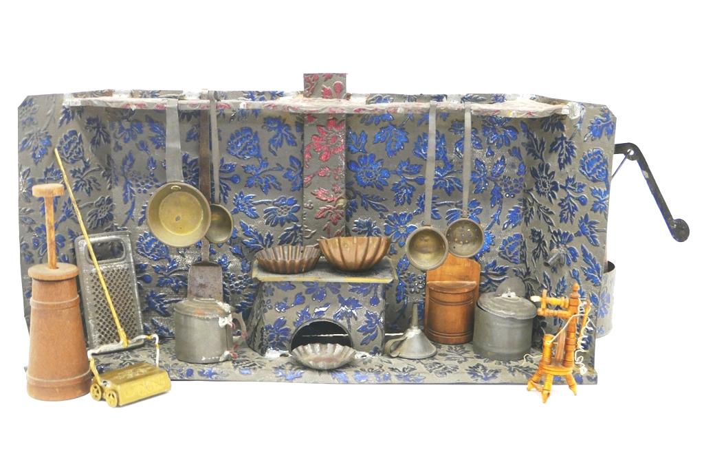 Nuremburg Tin Kitchen: Antique Nuremburg tin kitchen circa 1890, embossed tin construction with built in water pump and stove 15.5"W, 2.5"D, 7.25"H, comes with a selection of tin and brass ladles and strainer, tin covered c