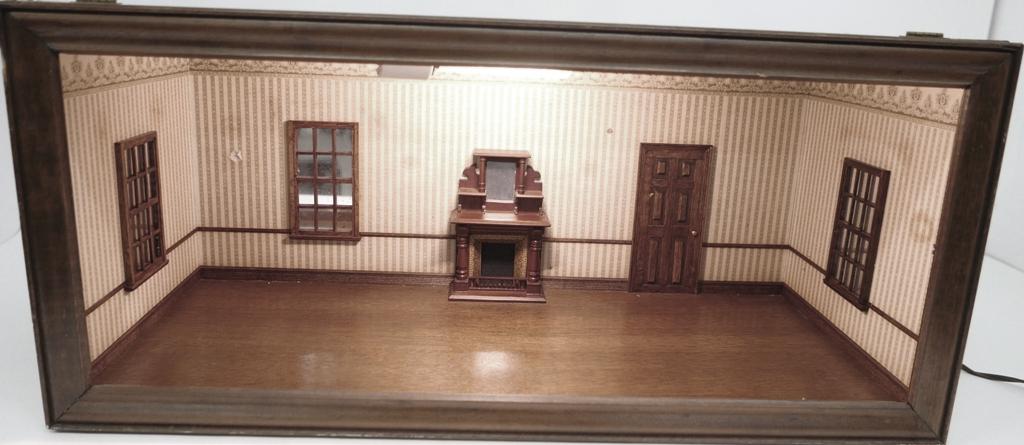 Vintage Living Room Box Dollhouse: Older single room wood box, plywood exterior covered with wallpaper, solid wood hinged front with glass panel, interior has electric light on ceiling, wallpaper, Victorian style fireplace, faux entry 