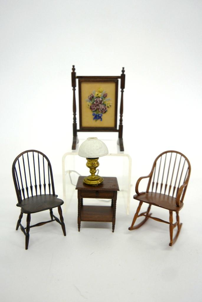 William Clinger Dollhouse Chairs & Others: William Clinger sack back Windsor armchair 3.25"H, hoop back Windsor chair 3.25"H, Crawford mahogany one drawer table with turned legs 1.75"H with an electrified brass parlor lamp, floral needle point