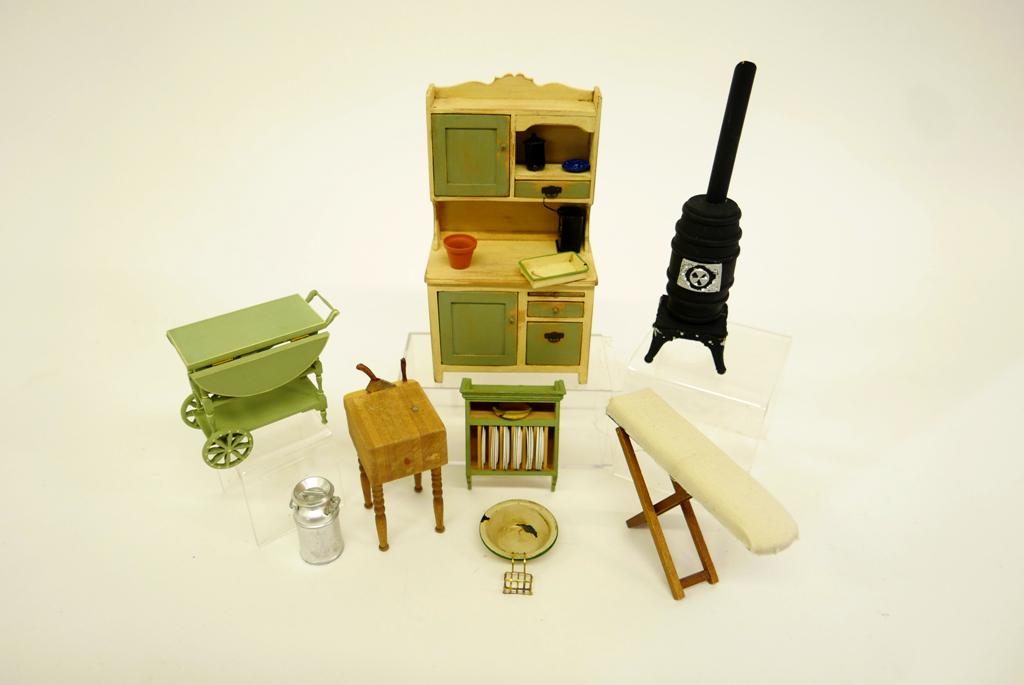Dukeman Dollhouse Kitchen Furniture & Others: C. Dukeman kitchen cabinet with distressed paint 3.5"W, 6.25"H with matching hanging plate rack, also includes unsigned cutting block, milk can, wood and tin stove 6"H, commercial tea cart 3"L