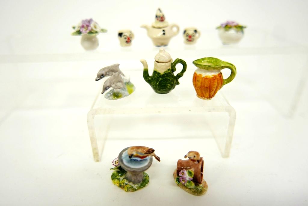 Dalton & Casson Dollhouse Porcelain Miniatures: Five tiny Ann Dalton miniatures include bird on a overturned pot .75"H, bird drinking in birdbath, pair of jumping dolphins and two flowers in pot, Valerie Casson carrot form pitcher, FA signed clown 