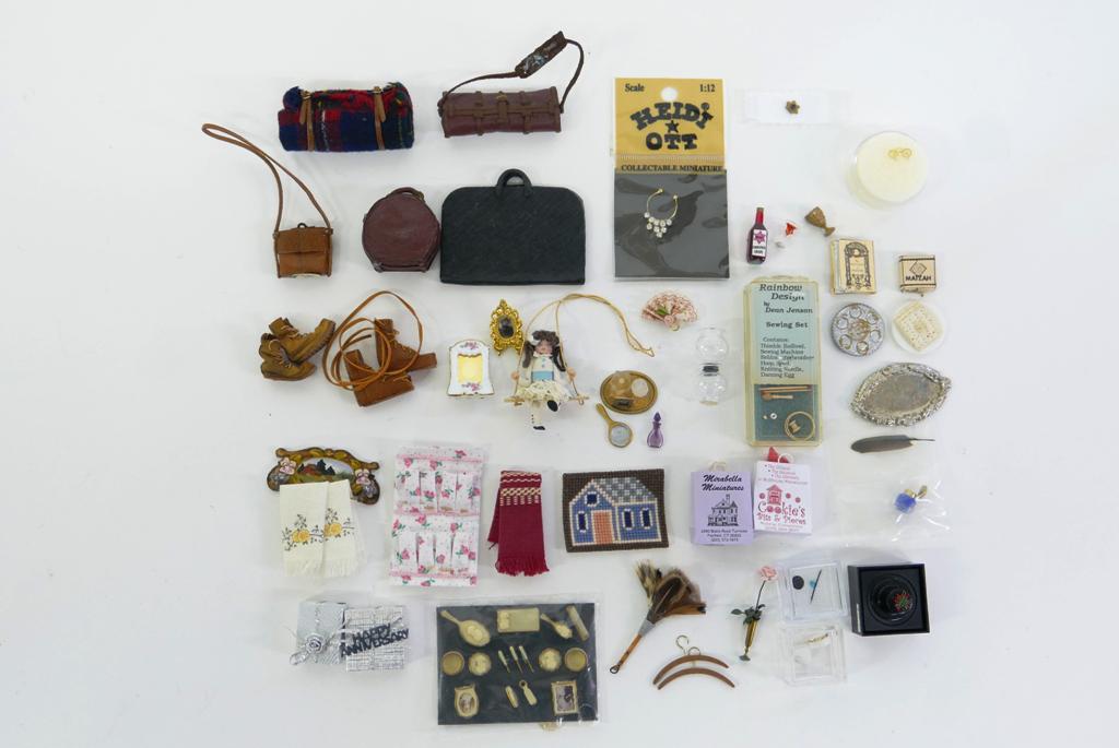 Dollhouse Lady's Accessories, Luggage & Judaica: Assortment of lady's perfume, dresser items, pin cushions, presents, towels, shopping bags, leather portfolio 2 5/8"W, leather luggage and boots, blanket roll tied with leather straps, selection of Ju
