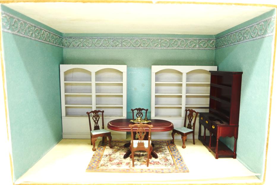 Small Furnished Dining Room Box Dollhouse: Small plywood room box with paper lined interior, pair of large wood display cases, Classics dining room table, four Raine Samuel Chase Chippendale style side chairs, and a commercial pewter cupboard,