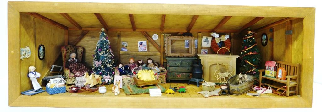 Furnished Attic Room Box Dollhouse: Long attic wood room box with slanted roof and sides has exposed beams and joists, wood floor with faux board edges, contains a vintage typewriter pencil sharpener, vintage fabric wing chair and sofa,