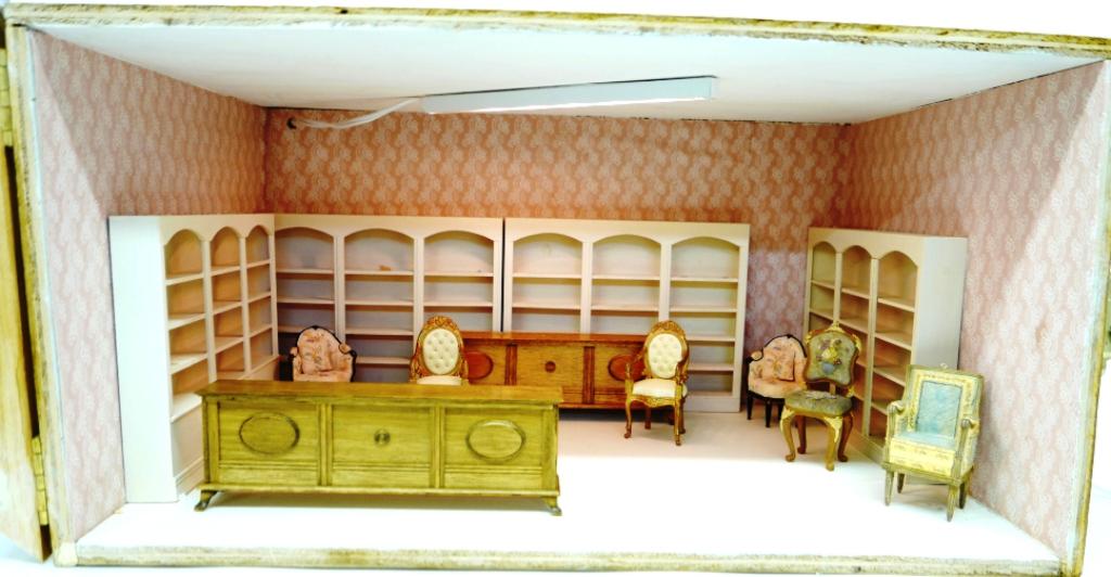 Furnished Store Room Box Dollhouse: Vintage plywood room box has hinged front door, interior has painted ceiling with electric lighting, paper on walls and floor, contains four triple display cases, two wood counters and six cast resin 