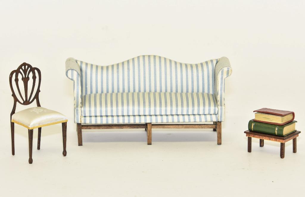 Jacqueline Andrews Sofa & Other Miniatures: Jacqueline Andrews camel back sofa 6.5"W, Robert Bernhard mahogany table with veneer skirt has two leather bound books with leather bound faux book hollow box on top 1 1/8"W, nicely made Sheraton styl