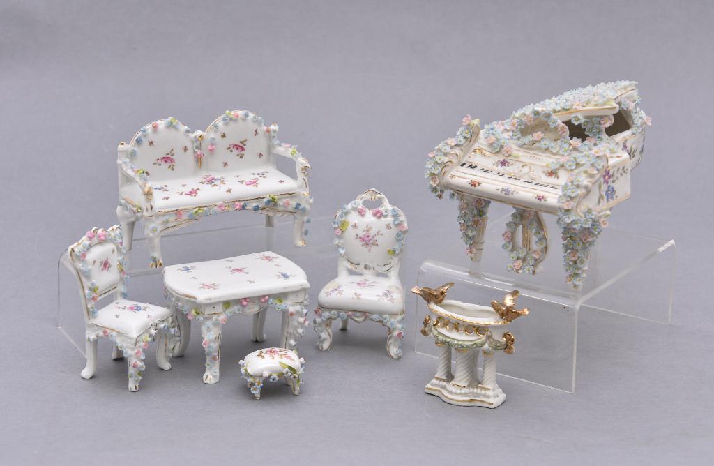 Antique German Porcelain Dollhouse Furniture: Group of hand painted antique porcelain decorated with applied flowers, grand piano is stamped Germany with a crown over V mark, includes piano 6"L, loveseat, desk with chair, chair with ottoman and b