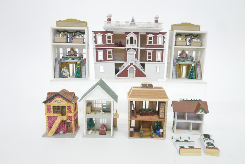 Group of Miniature Dollhouses: Group of very small cast resin dollhouses, Queen's three story townhouse has slide out front panels for access and contains a small amount of furniture 4.75"W, four furnished Hallmark open back buildi
