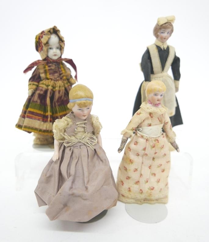 Four Antique & Vintage Dollhouse Dolls: Four all bisque jointed dollhouse dolls, bisque girl has original dress, bonnet and pantaloons 5"H, 1920's blonde bisque doll with original dress 5"H, early 20th century maid with original costume 5.7