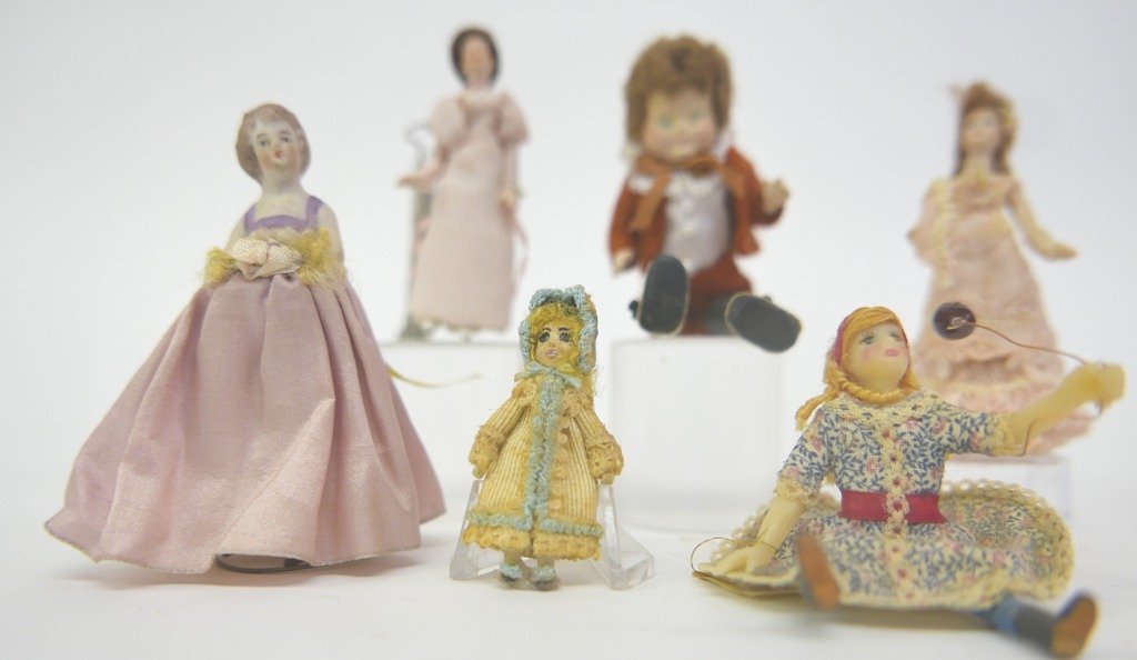 1/2" Scale Dollhouse Dolls & Others: Bisque 1/2" scale woman in gown carrying a fan 3"H, bisque woman in stripped gown 3"H, antique bisque girl with jointed legs has original dress 3"H, also includes an artisan bisque seated girl with ba