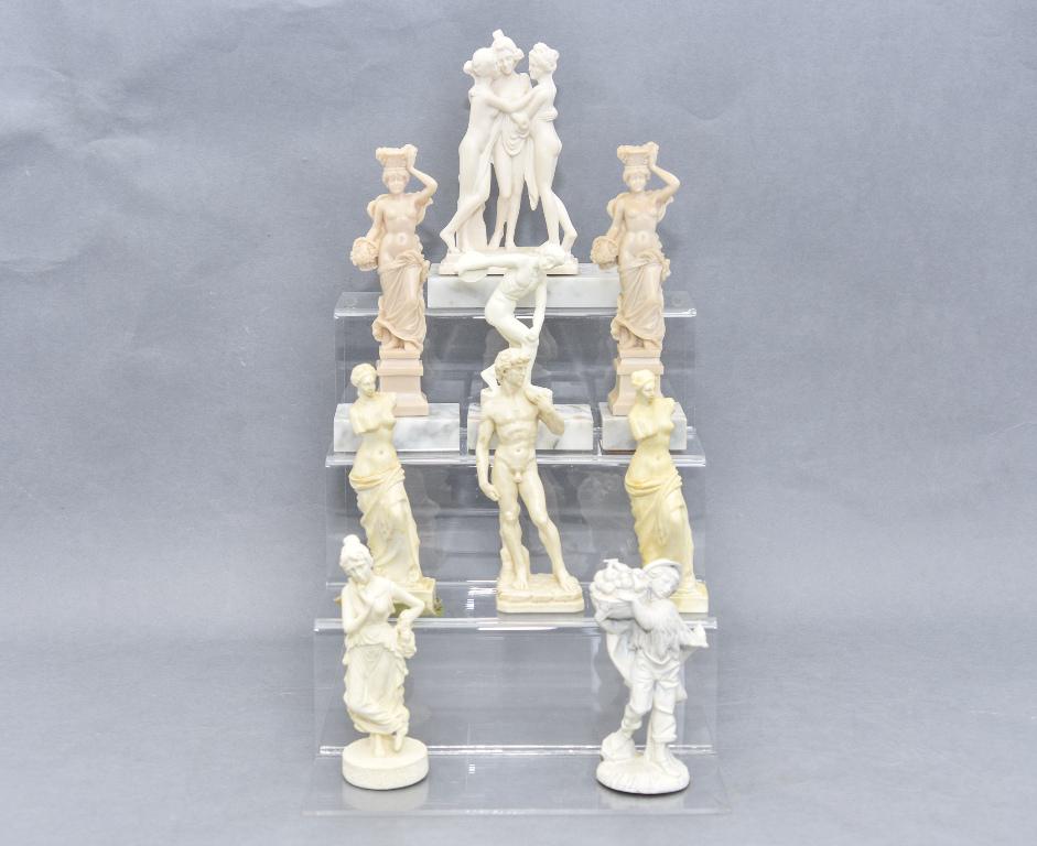 Nine Dollhouse Garden Classical Statues: Group of nine cast resin dollhouse scale garden statues including David 6"H, The Three Graces 3.5"W, 6"H, Discus Thrower and others, also includes seven marble blocks from trophy bases to be used as p