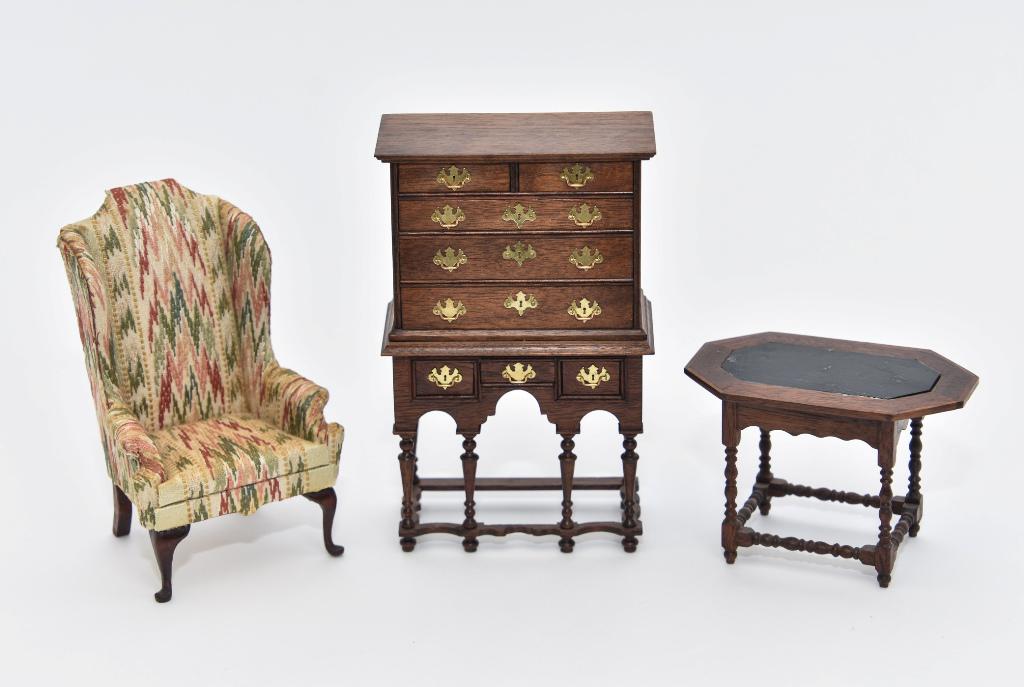 Dick & Bernhard Dollhouse Furniture Miniatures: Warren Dick mahogany chest on stand 3.5"W, 5 3/8"H, Dick mahogany octagon table with ebonized top center, scalloped skirt with single drawer, turned legs and stretchers 3.5"W, Robert Bernhard wing cha