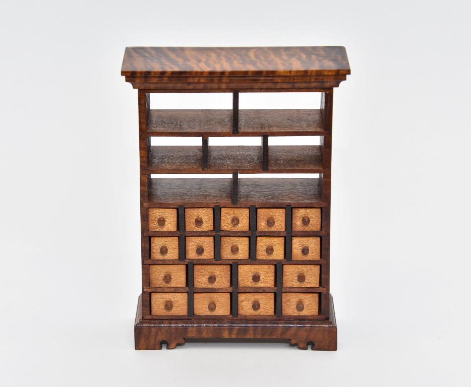 Artisan Collector's Cabinet Dollhouse Miniature: Very well made unsigned artisan cabinet, body is made of unusual highly figured curly mahogany, triple stepped top, 18 working drawers with turned wood knobs, base with detailed molding and straight b