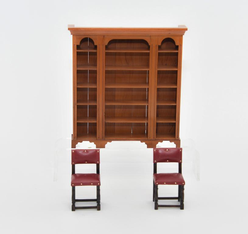 Ki-Kydd Library Bookcase & Chairs Miniatures: Paul M. Ki-Kydd cherry library triple bookcase with reeded uprights and straight bracket feet 6.5"W, 6 7/8"H, 1 2/8"D, pair of Ki-Kydd mahogany library or hall chairs with padded leather upholstery an