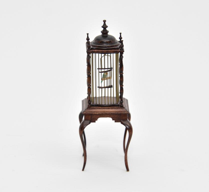 David Krupick Birdcage on Stand Miniature: David Krupick mahogany birdcage with brass bars and turned finials on a square base with scrolled skirt and cabriole legs 1.75" square by 5"H