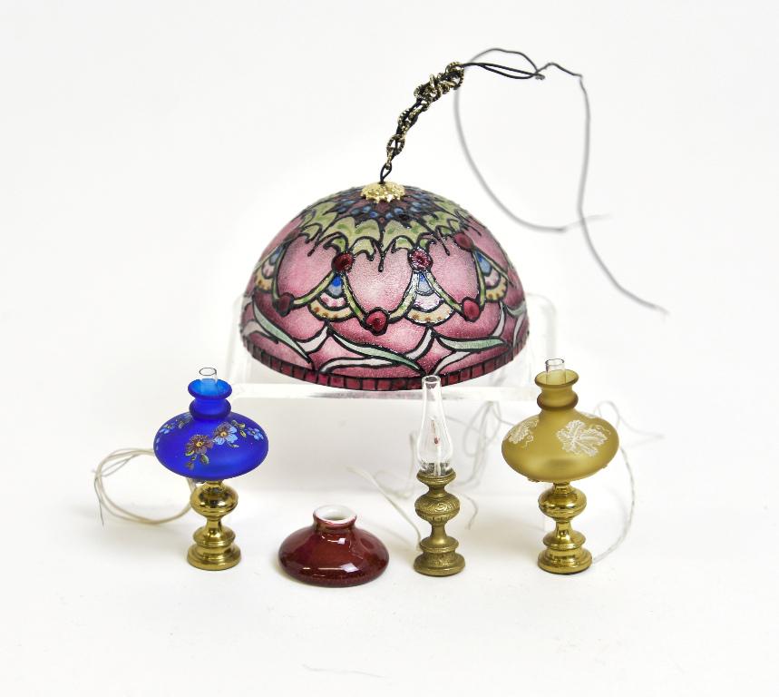 Two Ferenc Albert Table Lamp Miniatures & Others: Two solid brass electrified table lamps with hand painted Ferenc Albert glass shades 1.75"H, solid brass electrified fluid style lamp with a Ni-Glo cased glass red over white shade 1 5/8"H, electrifie