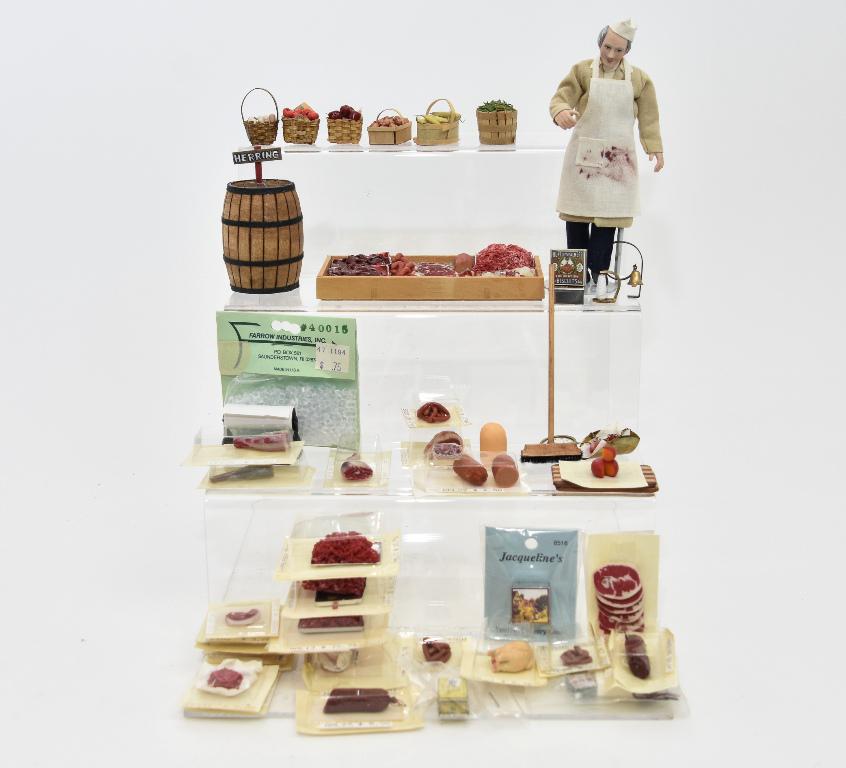 Dollhouse Grocer & Foods Miniatures: Rae Lynn bisque grocer 6"H, barrel of herrings, wood case with meats on ice 2.5" by 5", Gail Wise baskets of turnips and corn on the cob, assorted baskets, brass hanging store scale, Clare-Bell door b