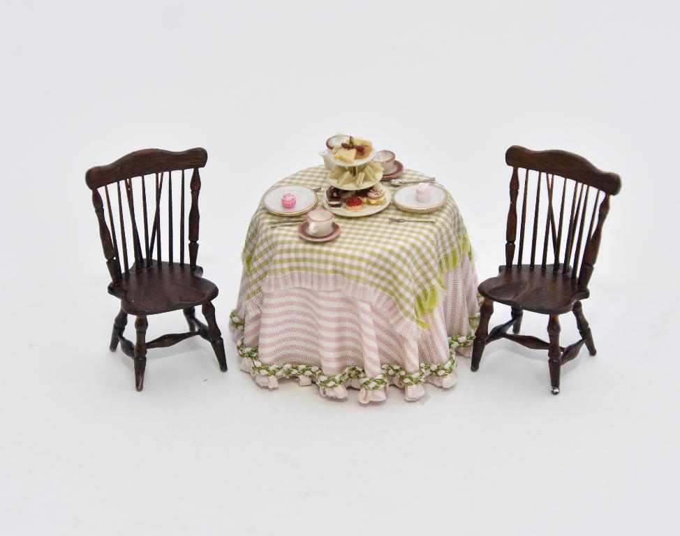 William Clinger 1/2" Scale Windsor Dollhouse Chairs: Pair of William Clinger 1/2" scale dollhouse mahogany brace back Windsor chairs 1 5/8"H, also includes a draped table with china tea set a three tier dessert tray 1.25"H, food by Lesley Burgess of The