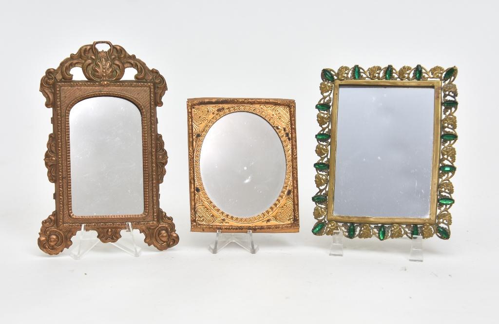 Three Dollhouse Ormolu Miniature Mirrors: Antique dollhouse ormolu frame with oval mirror 2.75" by 3.5", vintage ormolu ornate rococo mirror 3" by 5.5", vintage rectangular ormolu mirror set with green glass stones 3.5" by 4.5"