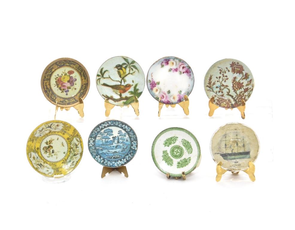 Seven Ellen Blauer Dollhouse Miniature Dishes: Seven Ellen Krucker Blauer decorated metal dishes in assorted styles, largest 1 1/8"D, also includes a similar unsigned clipper ship plate
