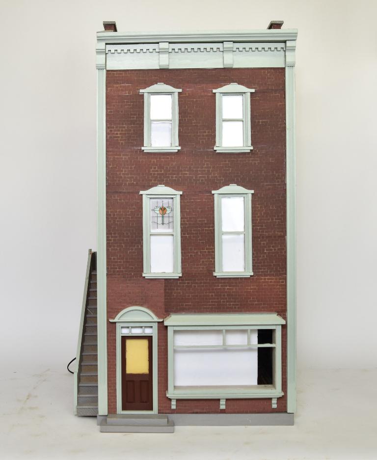 Brick Townhouse Dollhouse: Three story city townhouse has a paint and brick patterned paper covered exterior with four wood window frames, large bay window, fixed front door and side staircase leading to the second floor, hinge