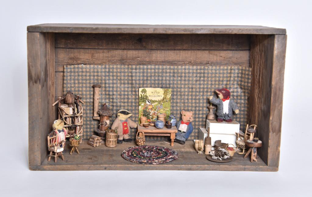 Donna Wormwood Wind In The Willows Room Box: Small antique wood crate designed after the book The Wind In The Willows, contains Donna Harrington Wormwood 1/2" scale whimsical stove 4.5"H, table with lamp, chairs and book with nut lamp and bark b