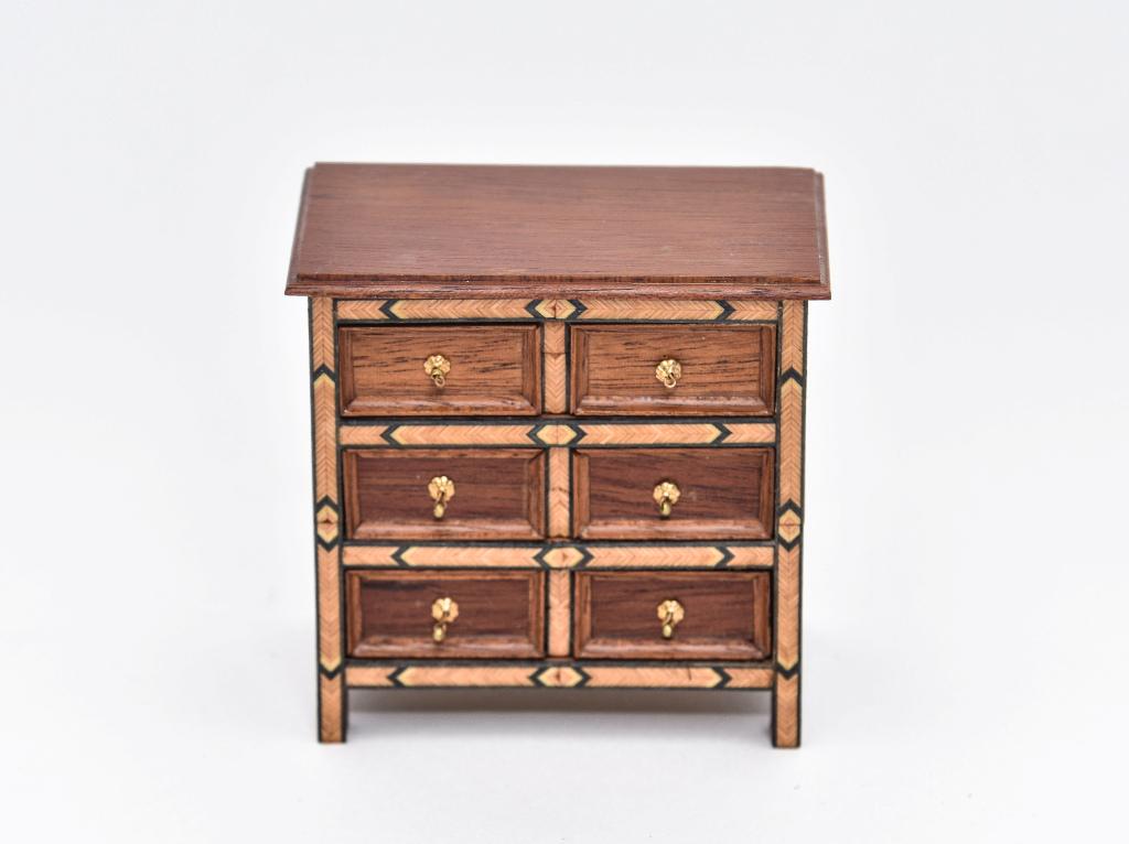 Dolores Rawding MMA Miniature Dresser: Dolores V. Rawding dollhouse miniature dresser, mahogany top with thumb molded edge, paneled sides, front edges trimmed with arrow veneer in contrasting colors, signed DVR Metropolitan Museum, 3.25"W,