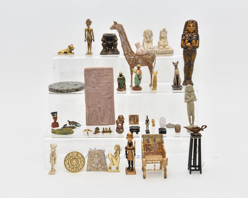 Egyptian style Dollhouse Miniature Accessories: Blue and gold King Tut statue 6 3/8"H, carved wood throne chair 3.25"H, pair of T. Dudley Sphinxes 4"L, artisan King Tut statue with illegible initials 4.25"H, carved stone Maahes statue 2.5"H, two bl
