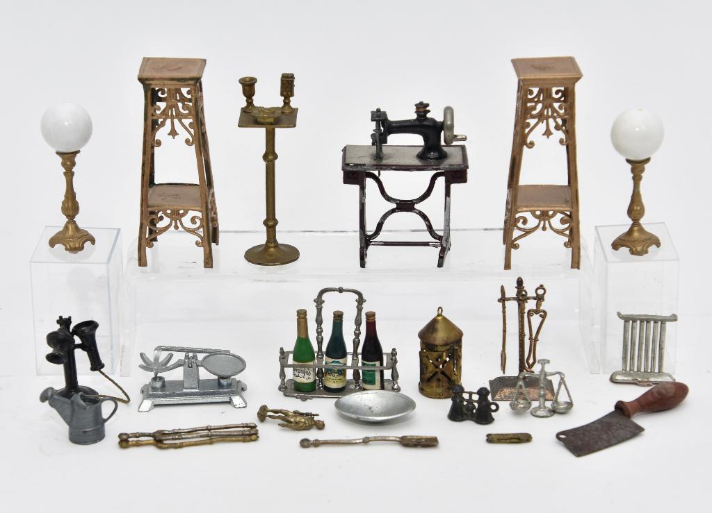 Vintage Soft Metal Dollhouse Accessories: Pair of plant stands 3.5"H, working German hand crank sewing machine 2"W, pair of lamps with white glass globes 2.5"H, bottle Tantalus 2"W, smoking stand, kitchen scale, phone, fireplace tools on stan