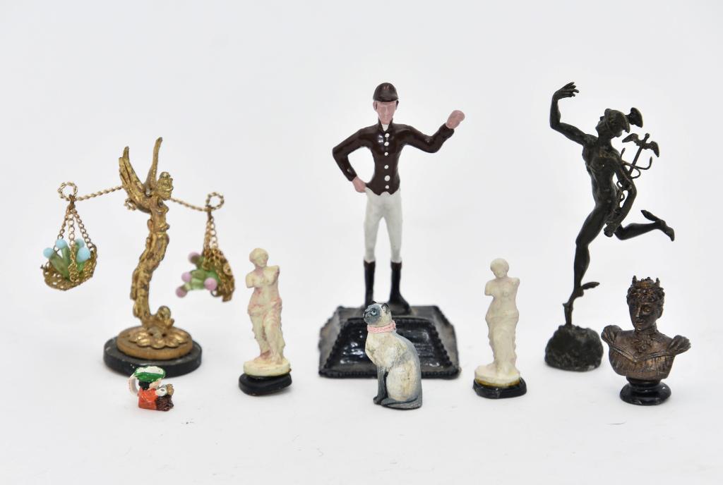 Assorted Dollhouse Metal Statues: Group of unsigned dollhouse metal statues, lawn jockey place card holder 3"H, cast brass angel form scale on wood base 2.5"H, statue of Hermes the messenger of the gods 3"H, pair of Greek style women 