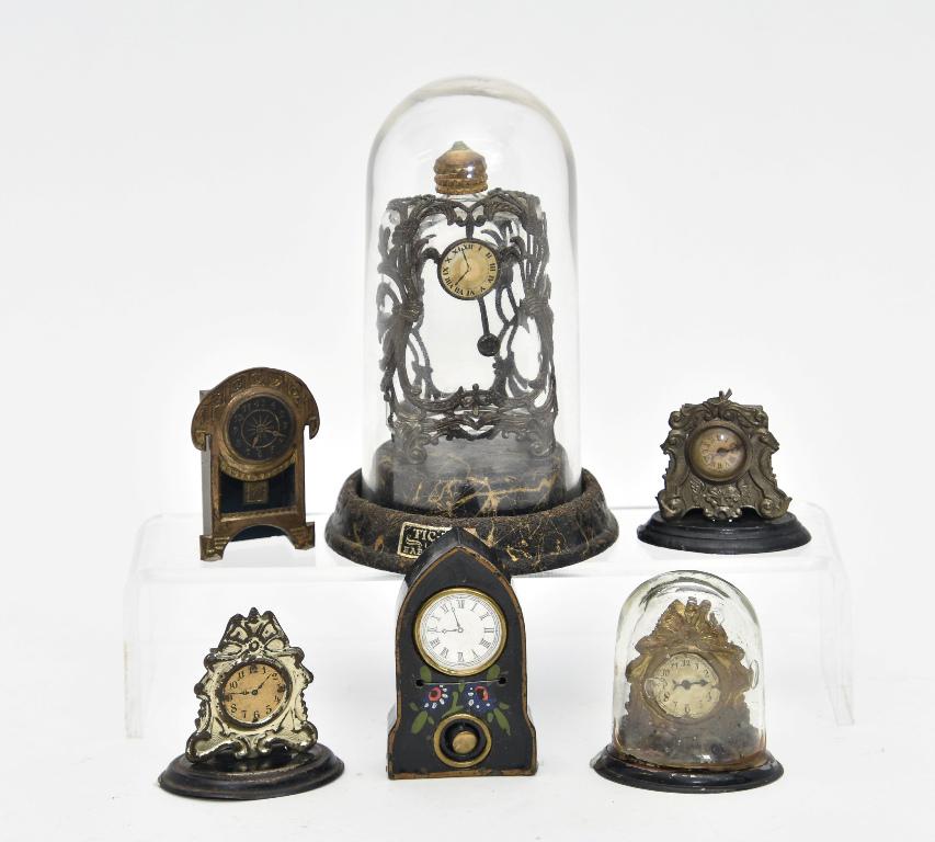 Antique Dollhouse Clock Miniatures: Antique Tic Toc cosmetic bottle inside of a clock form Art Nouveau frame under original glass dome on pressed paper base with partial label5.5"H, four ormolu mantel clocks including two with toy wind-