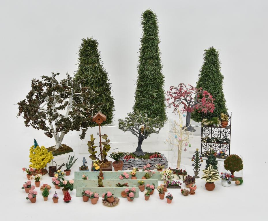 Large Assortment Of Dollhouse Gardening Supplies: Dozens of small plants in clay and ceramic pots, small bushes and ferns, wood benches, nicely made birch tree 10"H, two artisan trees hiding the Cheshire Cat, one has illegible initials 6"H, pebble ra