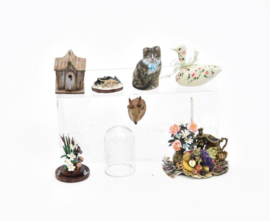 Assorted Small Artisan Dollhouse Accessories: Mary Hoots painted fabric cat 1.5"H, Hank Taylor wood birdhouse 1 1/8"W, painted wood goose decoy with illegible initials, Buckeye elaborate fruit and drink setting on a metal tray 1.75"W and a Buckey