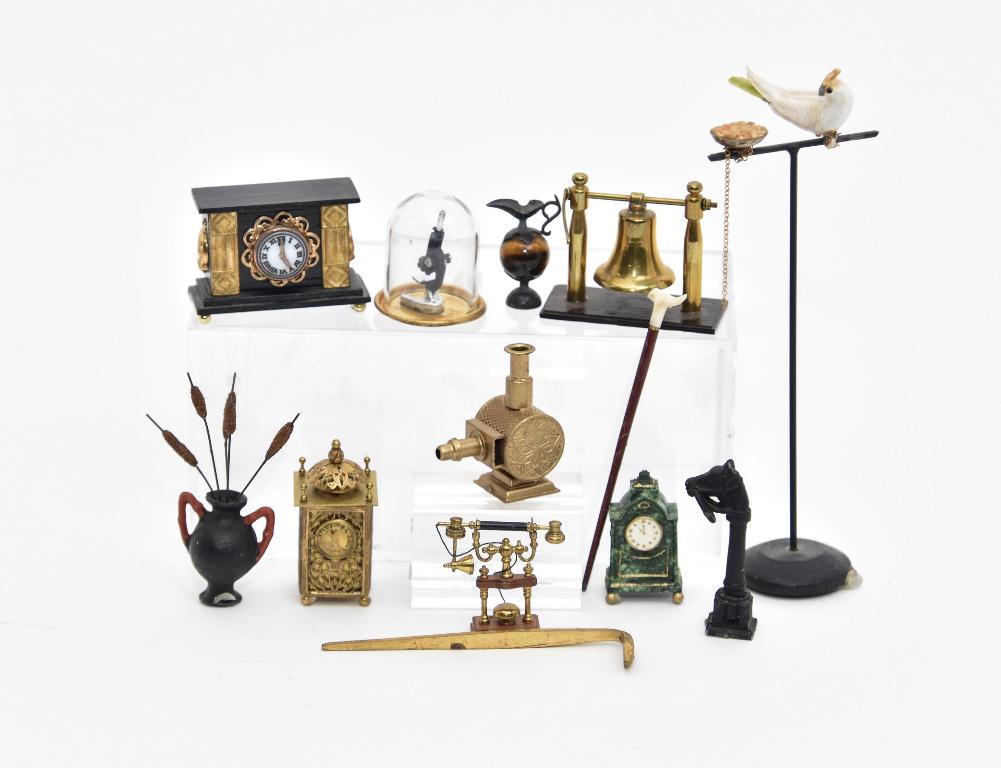 Small Metal Dollhouse Miniature Accessories: Allan Waters mahogany and brass telephone, quality brass bell on ebony base, Patti Highfill mantel clock, cast iron hitching post, Miniature Mart microscope under glass dome, photo projector, ormolu s